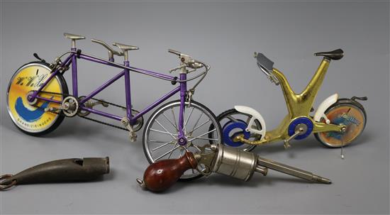 A group of novelty items including a horn whistle, a propelling pencil shaped as a revolver and two bicycle lighters (1 a tanden)